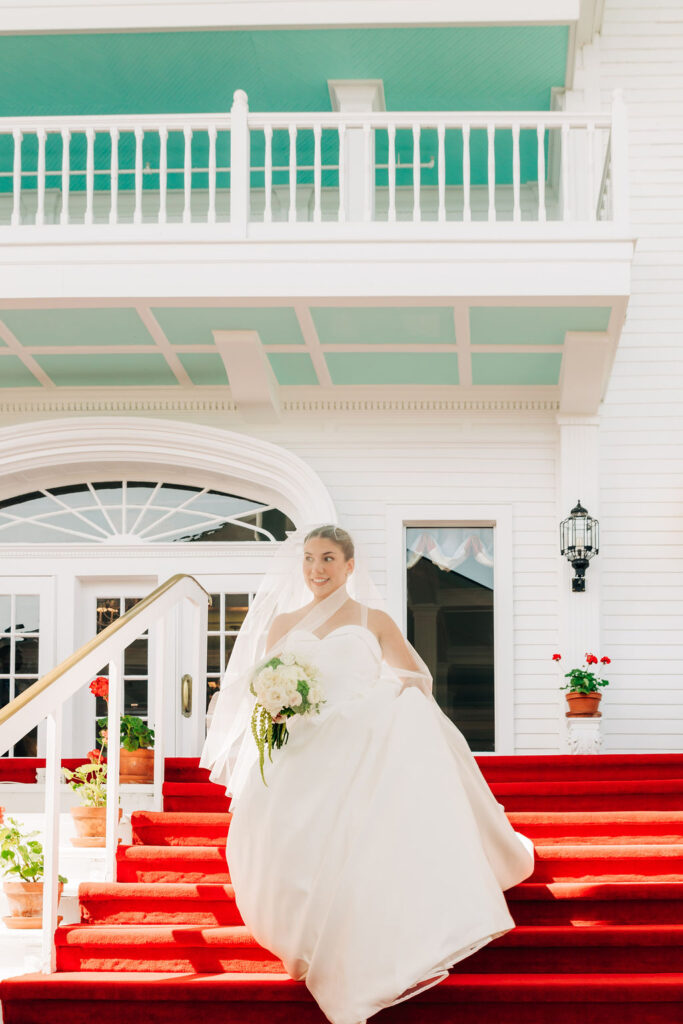 Bride walking down red steps at hotel on Mackinac Island