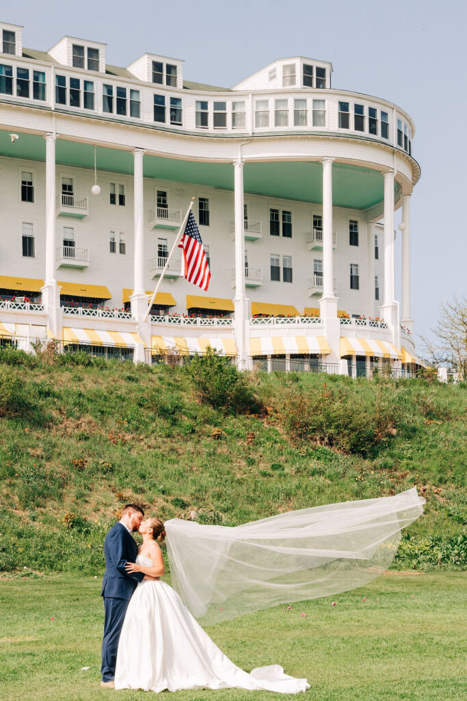 Couple kissing in front of Grand Hotel Wedding on Mackinac Island