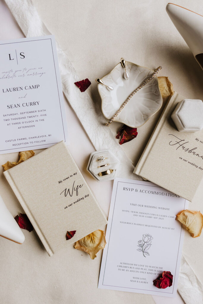 flat lay photo of wedding invitation suite with dried florals scattered throughout