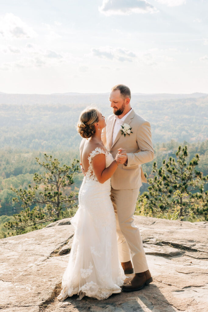 Couple in wedding attire dancing on top of Sugarloaf Mountain in Marquette Michigan